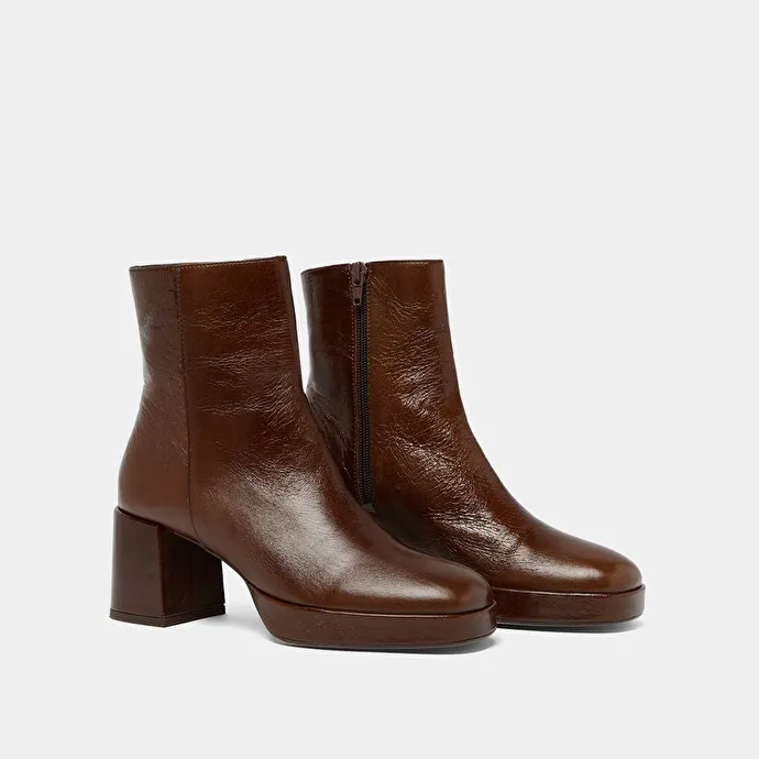 Round-toe boots in aged brown leather