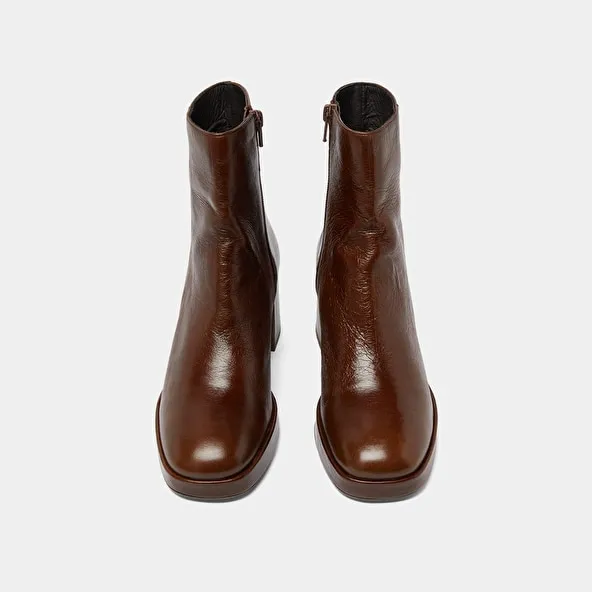 Round-toe boots in aged brown leather